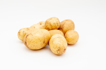 Fresh raw yellow potatoes on a white background. Harvest young potato.