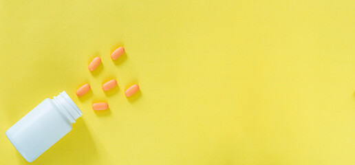 Pills and medicine bottles on a yellow background,All kinds of drugs to be put into the medicine bottle on the yellow background