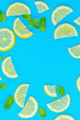Lemon and mint leaves on blue background,Frame from lemon slices and mint leaves on blue pastel table top view. Ingredients for summer drink and lemonade. Flat lay style.