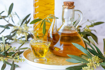 Olive branch and olive oil bottle isolated on white.
