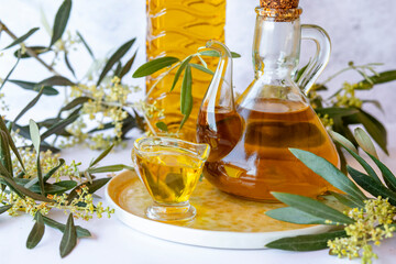 Olive branch and olive oil bottle isolated on white.