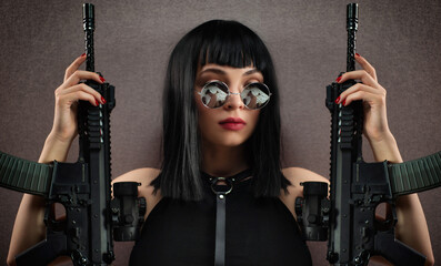 portrait of a female killer with an automatic rifle in round glasses
