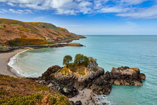 Image of Bouley Bay, Jersey CI, blue sky with cloud, at low tide.  Jersey, Channel Islands