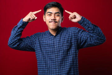 Handsome young man wearing casual shirt smiling pointing to head with both hands finger, great idea or thought, good memory