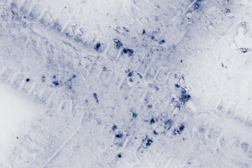 Trace of car tires in the fresh snow. Close up view from above