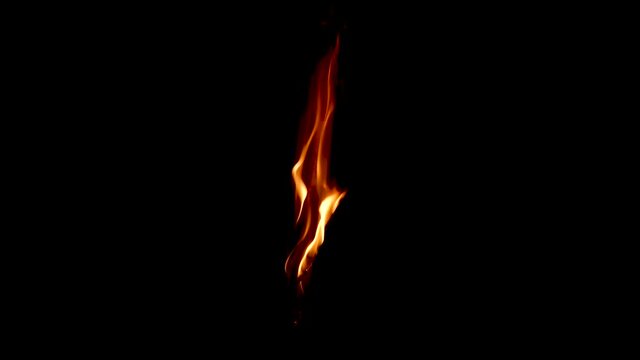 Burning a hanged paper isolated on dark background close up