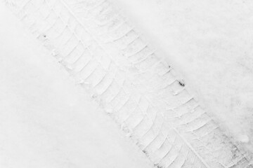 Trace of car tire in the fresh snow. Close up view from above