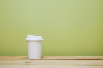 A paper cup of coffee on table. 