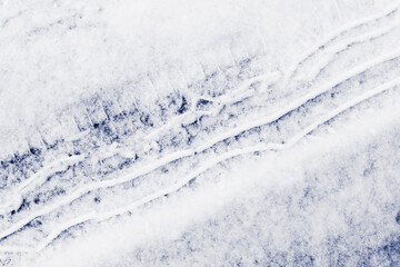 Trace of car tires in the fresh snow. Close up view from above