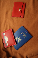 Leather wallets and passport on a brown background