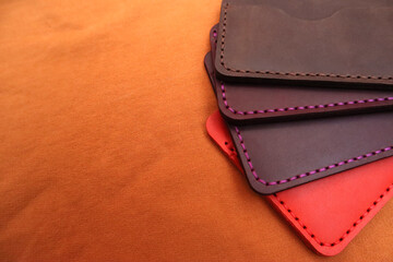 Handmade leather cardholders on a brown background