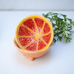 Ceramic cup in the form of half a grapefruit.