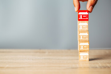 Cubes wood Franchise business,Businessman hand choose wooden blog with franchise marketing store...