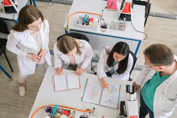 Professor discussing with students in science class