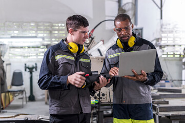 Robotics control engineers discussion and solve problems control panel of robot for setting programming for industrial robot arm controller in production plant factory