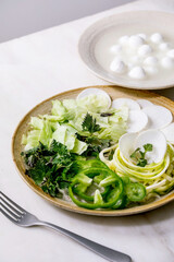 Fototapeta na wymiar Green raw vegetables and herbs for salad