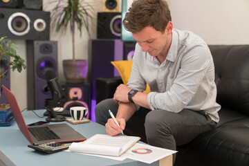 Entrepreneur signing document while sitting on sofa at home