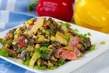 salat with fresh vegetable, paprika, tomato, papper, corn mushrooms and paprika in background.
