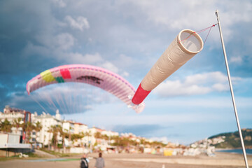 Windsock or windbag, wind direction indicator on the beach. Paragliding in Alanya.