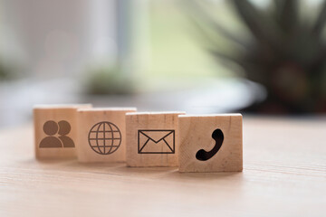 Hotline support contact communication concept. Contact us communication icons on wood cubes.