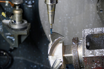 The  5-axis machining center cutting the boat propeller with solid ball end mill tool. The hi-precision part manufacturing process by multi-axis machining center.