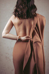 view of woman getting dress up naked back