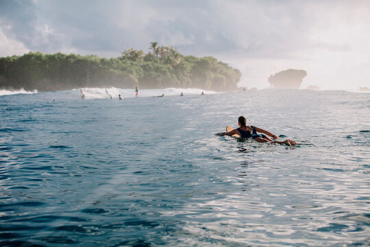 Woman on surfboard on the sea, Siargao Island, Philippines
