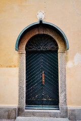 Fototapeta na wymiar Ancient wall of old building with wooden vintage door.