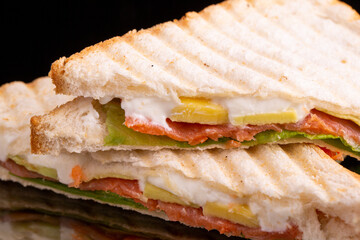 sandwich, grilled toast, cream cheese, salmon, avocado and lettuce leaves