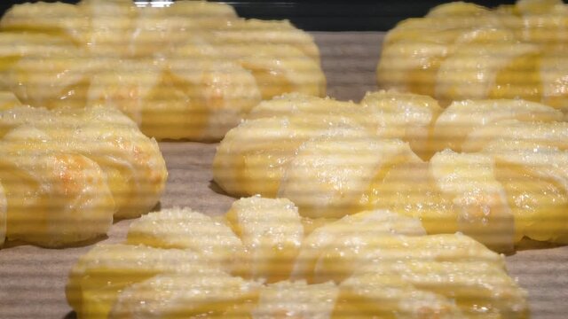 4K Time Lapse of baking process of pineapple puff pastry rings in oven, home made. Time-lapse video of sweet puff pastry cakes with pineapples baked in oven.