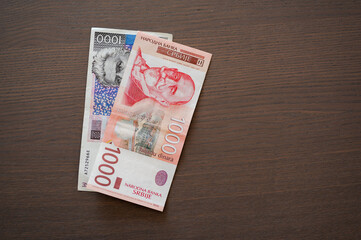 Serbian and Croatian paper money, 1000 kunas i 1000 dinars bills, flat lay.
