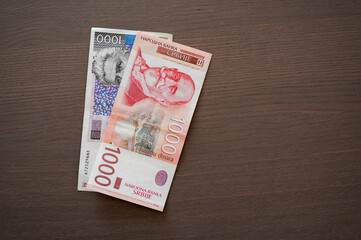 Obraz premium Serbian and Croatian paper money, 1000 kunas i 1000 dinars bills, flat lay.