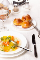 Plate with fresh hot soup on the table and homemade buns