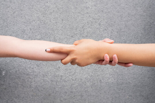 Studio shot of interconnected hands of two young women