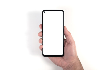 hand holding smartphone with blank white screen against white background, person using smartphone template with copy space