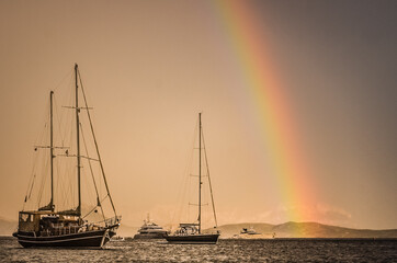 boats and rainbow on the sea © Kamila