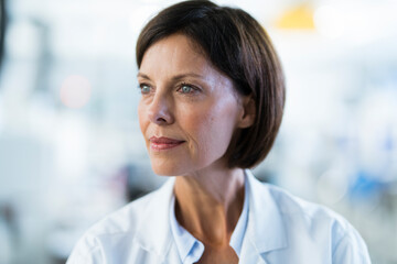 Female technician looking away at laboratory