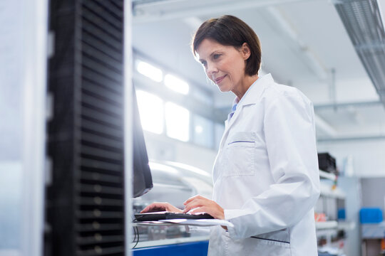 Female scientist using computer at laboratory