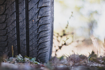 Fototapeta na wymiar Close up of car tire in the desert, safari