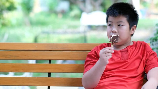 asian boy eating ice cream, delicious and happy concept
