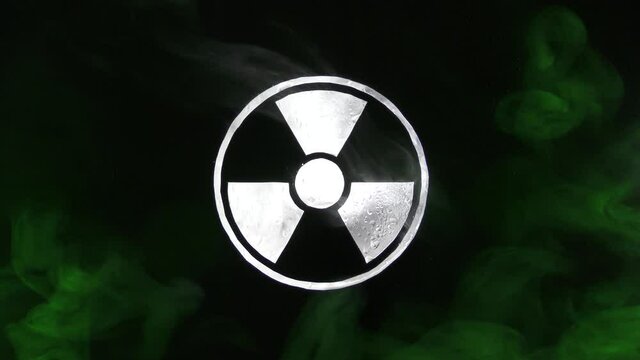 Radiation hazard sign with acid drops and smoke. Biohazard sign with droplets of smoke to warn of hazardous radioactive radiation.