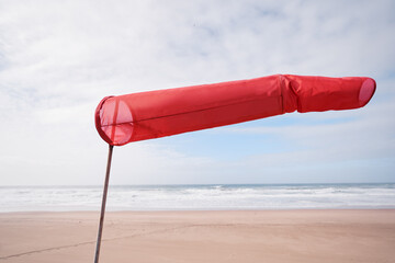 Windsock or windbag, wind direction indicator on the beach.