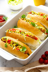 Homemade hot dogs with mustard and letuce toping on a bright background.