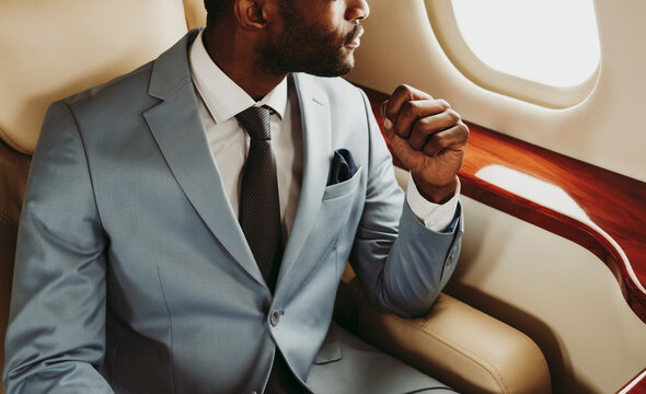 Businessman sitting on seat in private jet