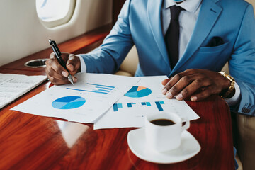 Businessman working on document in private jet