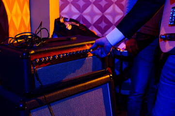 Male musician adjusting audio equipment at studio