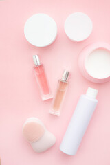 Layout on a pink cream background . Cosmetology. Care cosmetics. Skin care. Jars of cream. Pink background. Copy space. Article about the choice of cream. Spa.
