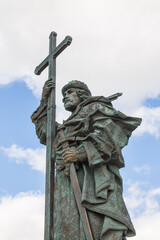 monument to Prince Vladimir with a cross close-up against a blue sky with white clouds in Moscow Russia