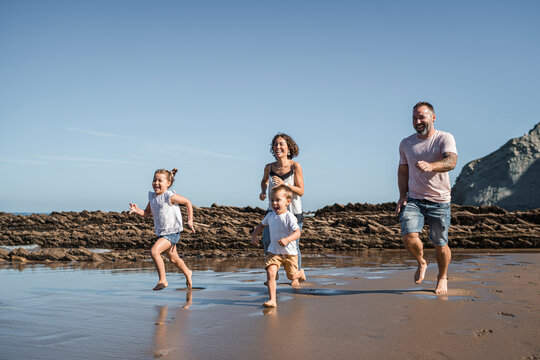 family with 2 children enjoying the beach and cliffs of the Basque country