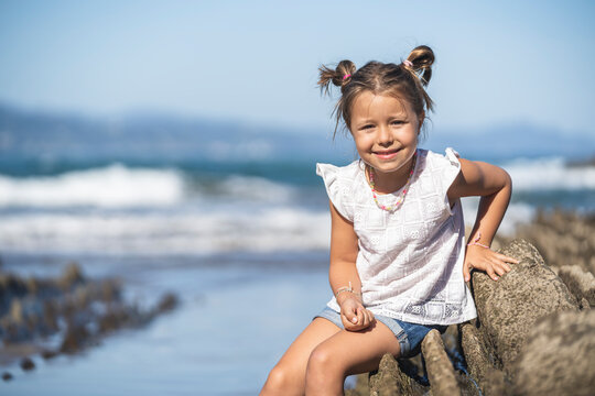 family with 2 children enjoying the beach and cliffs of the Basque country